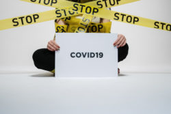 person holding a covid 19 sign