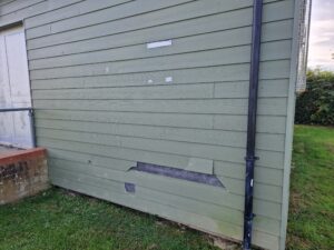 Picture of the damaged exterior boarding at Prestwood Community Centre